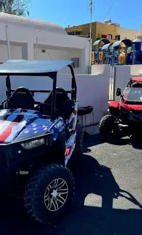 Buggies parked in front of the Rafale Rentals office in Santorini
