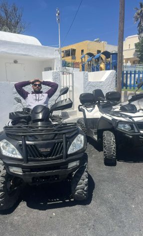 Customer riding a black and a white ATV in Santori