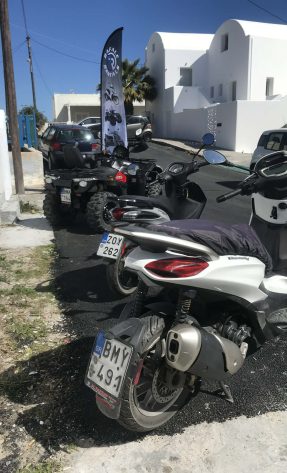 Piaggio Beverly scooter with ATVs in Santorini