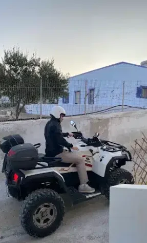Young tourist riding an ATV in Santorini